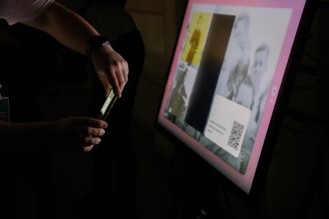 Persona usa su celular para escanear un código QR